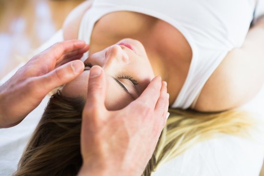 Relaxed pregnant woman enjoying reiki technique